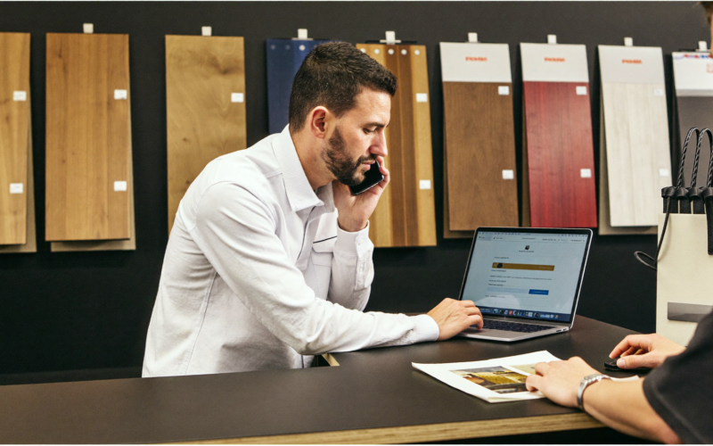 Flooring store owner replying to a new enquiry on his phone, speed to lead for flooring stores