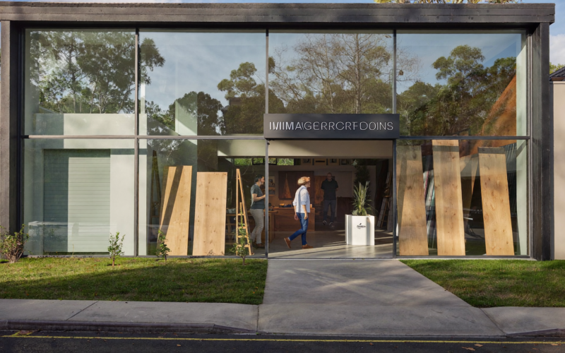 Couple walking into a modern flooring showroom at golden hour, flooring store marketing ideas that bring buyers in