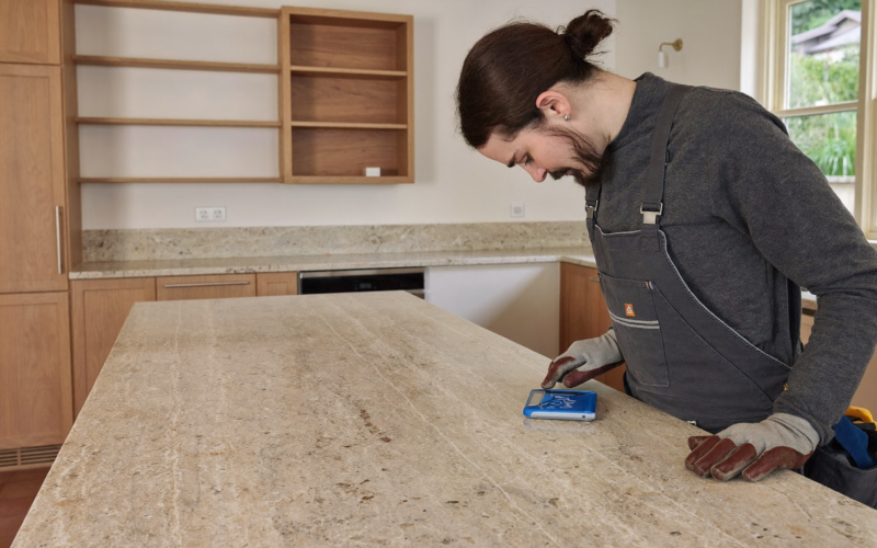Fabricator doing digital countertop templating on bare kitchen cabinets