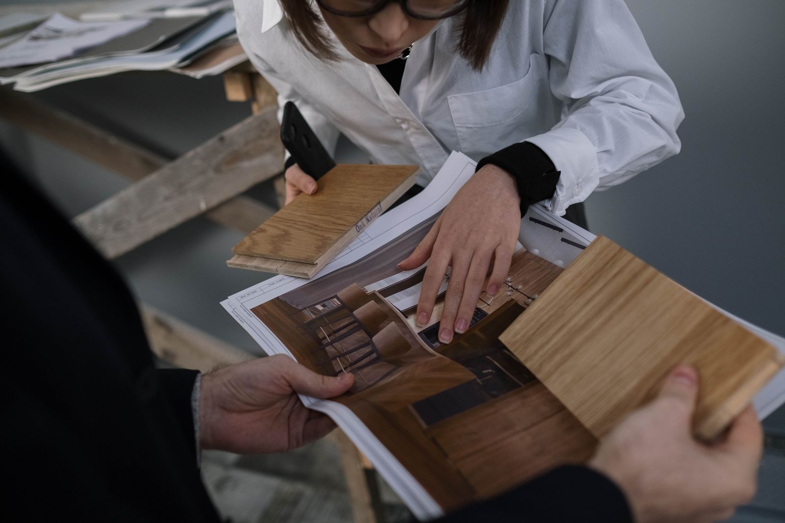 Comparing wood flooring samples on site, the first step in how to quote flooring jobs the same day