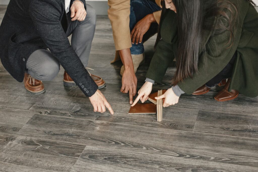 Customers choosing flooring options with a salesperson in a showroom