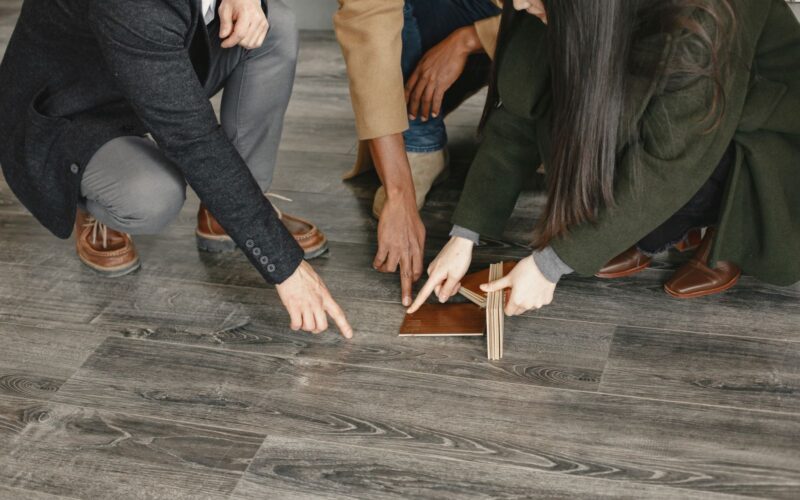 Customers choosing flooring options with a salesperson in a showroom