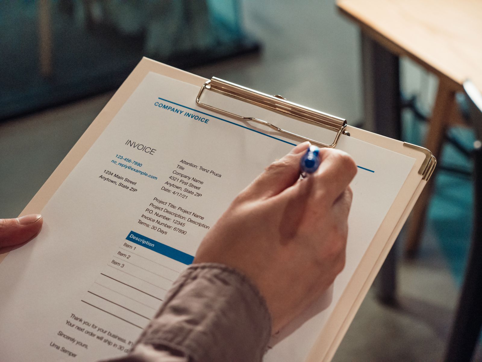 Invoice on a clipboard, the paperwork behind how flooring contractors get paid faster
